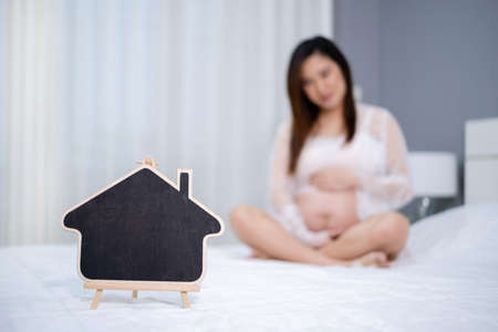 blank sign with pregnant woman in a bed