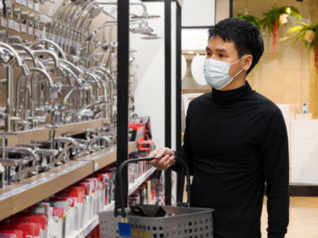 man shopping in department store and his wearing medical mask