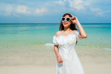 cheerful woman on the sea beach at Koh MunNork Island, Rayong, Thailandの写真素材