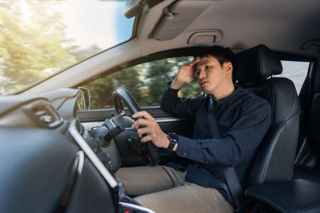 stressed man driver sitting inside a carの写真素材