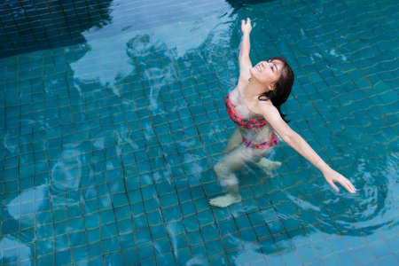 young woman relaxing in swimming pool