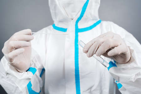 close up doctor in protective suit PPE holding Coronavirus(COVID-19) Nasal swab laboratory testの写真素材