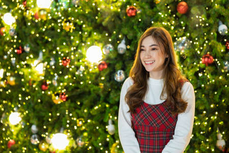 happy woman with Christmas tree, x-mas celebratingの写真素材