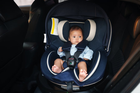 newborn baby sitting in an infant car seat, safety chair travellingの写真素材