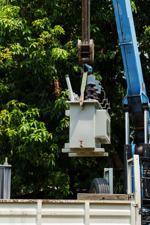crane hook lifts up the distribution transformer