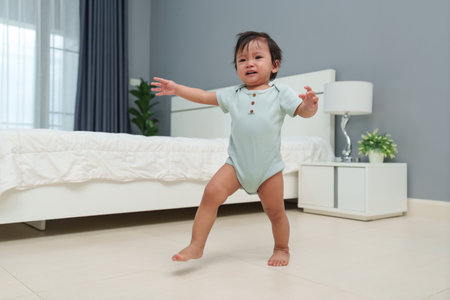crying infant baby walking first step at homeの写真素材