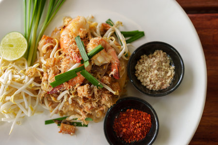 Pad Thai with shrimp and vegetables on a tableの写真素材