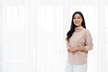 happy woman on a white window backgroundの写真素材