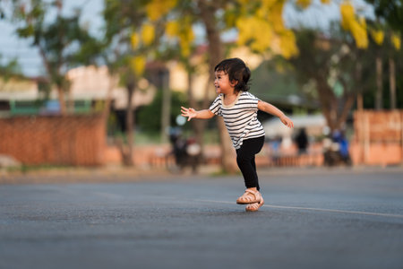 happy toddler girl running in the parkの写真素材