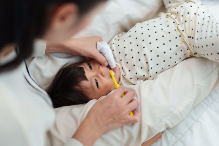 mother brushing her little daughters teeth. happy baby with tooth brushの写真素材