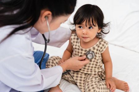 doctor using a stethoscope to istening toddler's chest. baby health conceptの写真素材