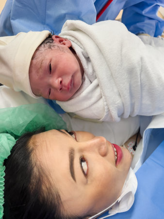 first sight of mother and her newborn baby after the Cesarean section in operation room