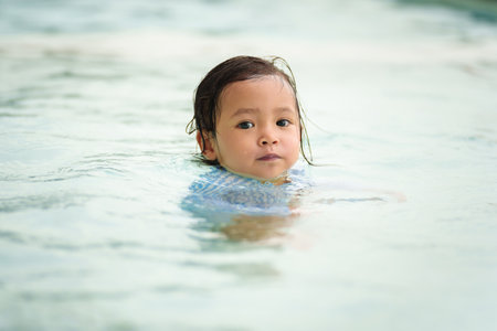 toddler baby float in the swimming poolの写真素材