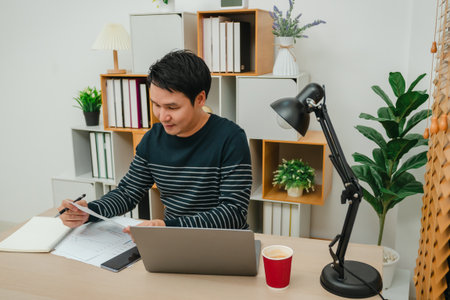 happy young man reading document or paperwork. working at home office