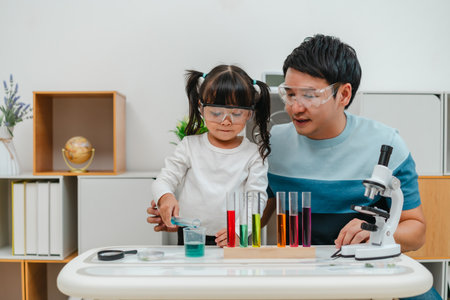 father and toddler girl scientist making chemical test with test tube and beaker. learning science...