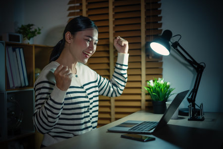 woman working with laptop at a nightの写真素材