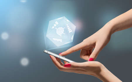 Hands keeps and touch smartphone with icons. Communication concept.の写真素材