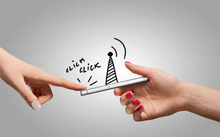 Hands keeps and touch smartphone with sketches. Communication concept.の写真素材