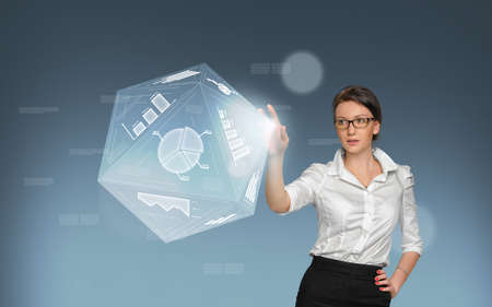 Business concept. Pretty young woman in office suit touch in screen with icons and graphicの写真素材