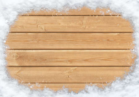 Top view of wooden surface covered with snow of the shape of a circleの写真素材