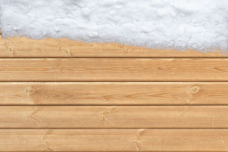 Top view of wooden surface with snow on one sideの写真素材