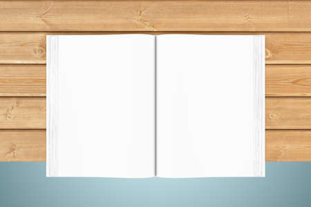 Three-dimensional illustration of white blank open book on wooden planksの写真素材