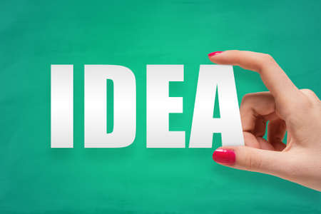 A woman hand holding the word idea. Business conceptの写真素材