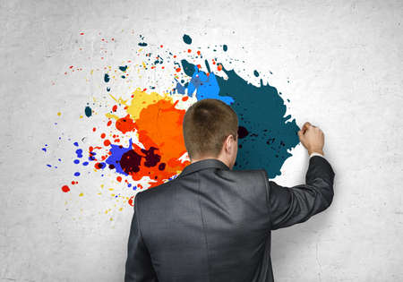 ? businessman drawing his bright ideas on a white wallの写真素材