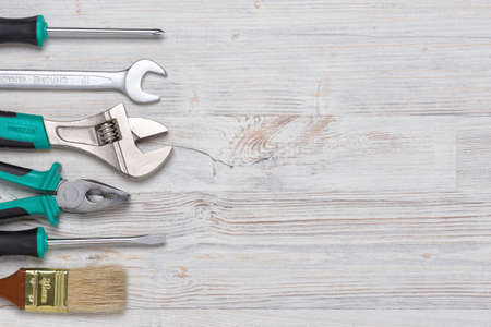 Top view of construction instruments and tools on wooden DIY workbench with open space at center.の写真素材