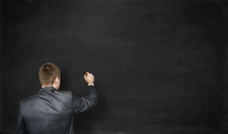 Businessman going to write something on a empty black wallの写真素材