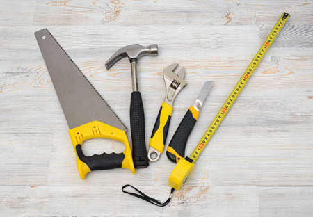 The top view of different working tools lying on wooden surfaceの写真素材