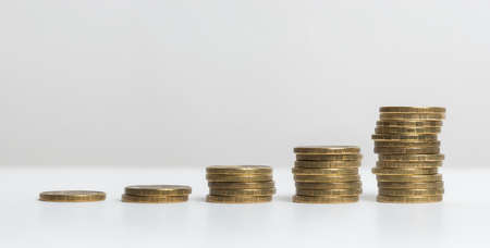 Five small stacks of coins, from small to big isolated on white background. Russian rouble