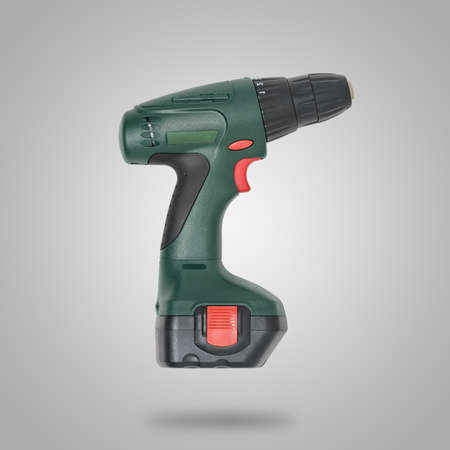Drill with battery on gray background