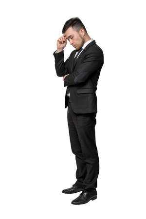 Full portrait of young man in business suit, thinking about something, isolated on white backgroundの写真素材