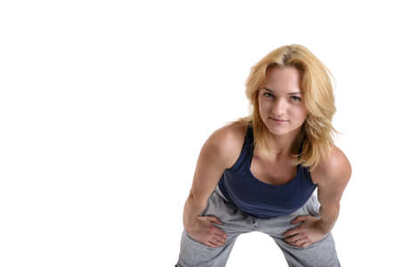 Beautiful smiling fitness woman wearing black sport pants and purple sport shoes isolated on white backgroundの写真素材