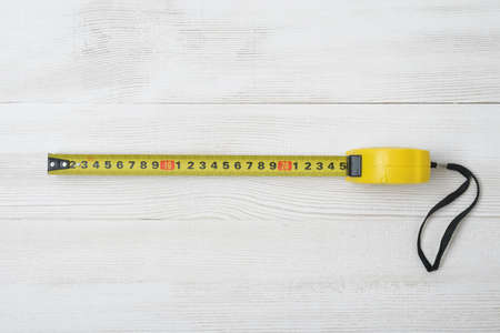 Top view of  tape measure on white wooden DIY workbench. Flat layの写真素材