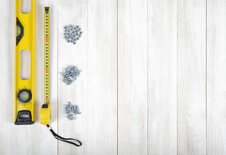 Layout of tools for constructing and manufacturing including nuts, screws, nail, tape measure and...
