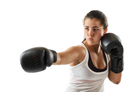 Sporty muscular boxer woman during boxing exercise making direct hit in black gloves