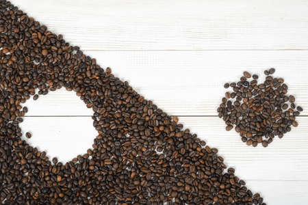 Top view of coffee beans making a modified symbol Yin yang with border diagonally.の写真素材