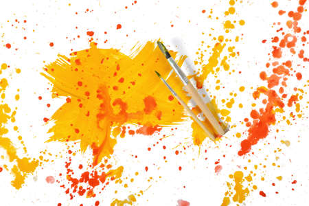 Cross shaped strokes with yellow and red gouache forming spots on a white canvas.の写真素材