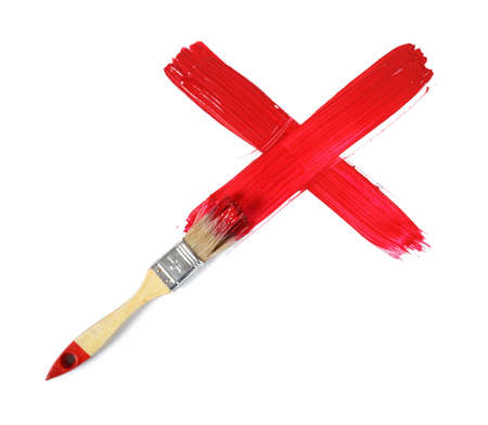Paint brush making gouache red cross mark on white background.の写真素材