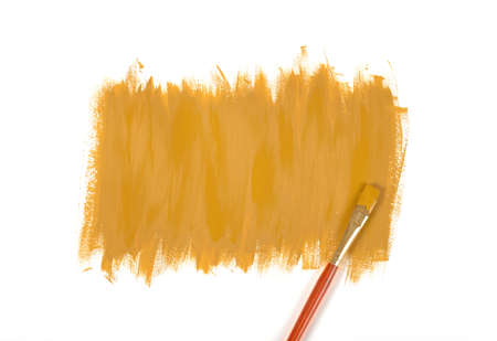 Color of mustard gouache hand-painted daub with used paint brushの写真素材