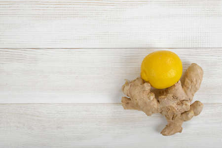 Top view of lemon and ginger on wooden surface with copy spaceの写真素材