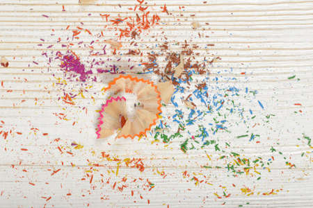 Different colored shavings from yellow, red,  blue, pink and orange pencils with copy space.の写真素材