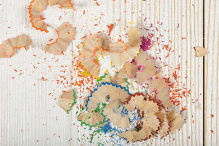 Different colored shavings from yellow, red,  blue, pink and orange pencils with copy space.の写真素材