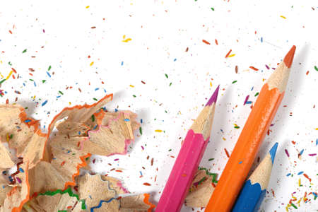 Closeup of colored pencils and its shavings. Workplace of designer. Working material. Sharpening...