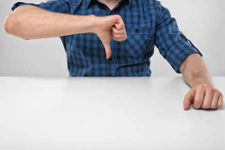 Cropped image of masculine hands showing thumbs down. Hand gesture. Bad job. Symbols and gestures....