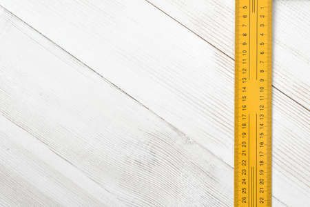 Top view of centimeter ruler placed on the right side of wooden surface with open space. Measurement. Hand tool. Mend and repair. Parts for repair.の写真素材