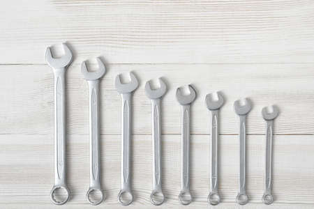 Different sized wrenches placed from the biggest to the smallest in a row. Top view composition. Hexagonal shape. Hand tool. Tools for carpentry work. Type of fastener. Mend and repair. Parts for repair.の写真素材