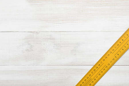 Top view of centimeter ruler placed on the right side of wooden surface with open space. Measurement. Hand tool. Mend and repair. Parts for repair.の写真素材